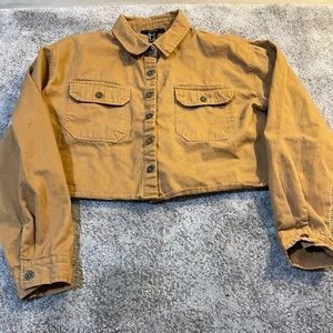 Cropped light brown jacket.